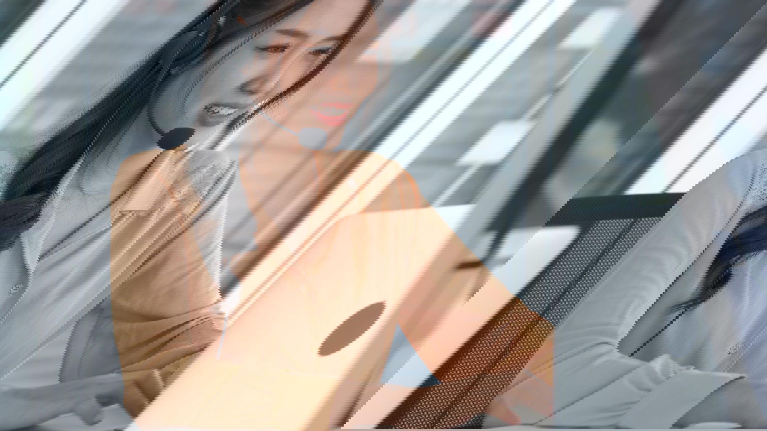 Businesswoman wearing headset working actively in office . Call center, telemarketing, customer support agent provide service on telephone video conference call.